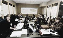 A group of public health professionals sitting around a table during a meeting.