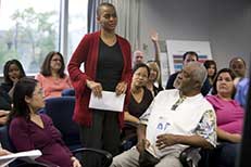 Community gathering with members asking questions