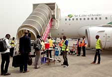 Health workers screen passengers for signs of ill health before they board an airplane. 