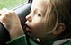 young girl in vehicle looking out a window