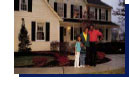 family standing in front of home