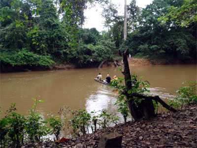 RITE team members take a canoe as the last leg of their day-long journey to a remote village with suspected Ebola cases.