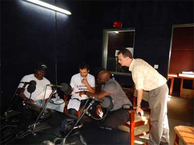 Fred and CDC epidemiologist Desmond work with Sierra Leonean recording stars Jimmy B. and Nasser Ayoub to record PSAs for the 