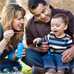 Photo of family playing outside with baby.