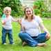 A mother and toddler on their lawn