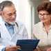 Doctor and patient looking at clipboard