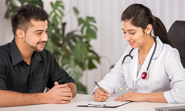 Photo of a doctor speaking to a patient.