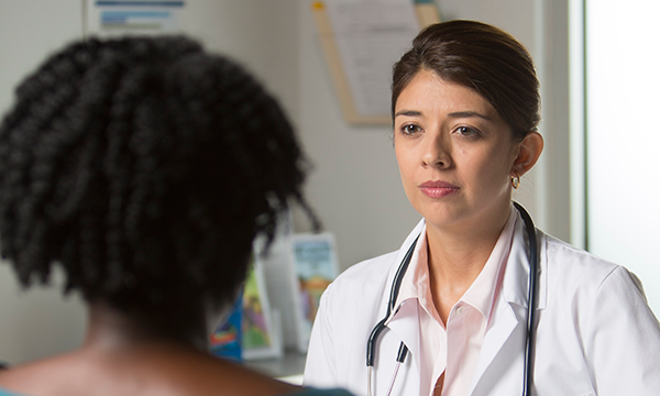 Photo of doctor talking to patient.