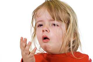 A little girl in red with flu looking sick.