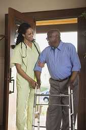 Nurse helping man with water