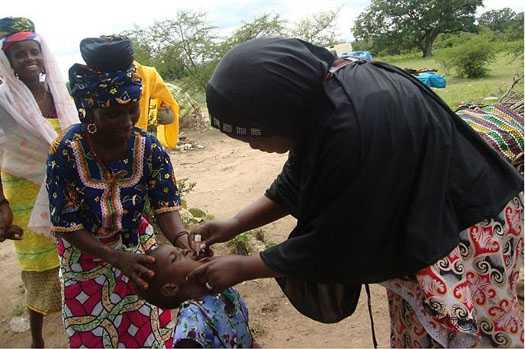 	Woman giving a child medicine