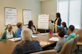 instructor talking to adult class of SME program