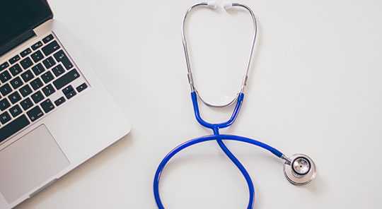 image of a stethoscope and a laptop