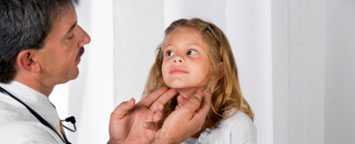 Doctor examining a young girl