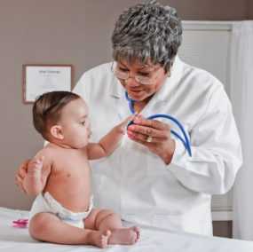 doctor holding sleeping baby