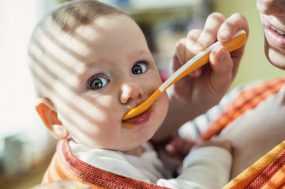 Photo: Woman feeding a baby