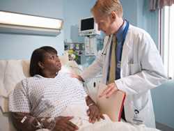 A doctor checking on a female hospital patient