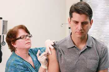 A nurse giving a flu shot to a patient