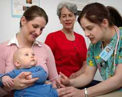 A doctor giving a flu shot to a baby.