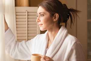 Photo of a woman looking out a window