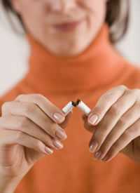 Woman breaking a cigarette in half