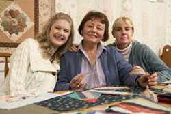 Photo of three women knitting.