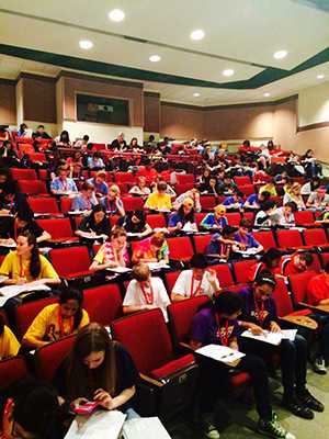 	high school and middle school students sitting in classroom.