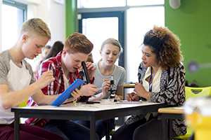 Students experimenting with microscopes in a science lesson