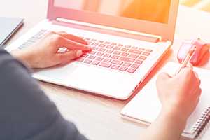 Close up of woman hands using laptop