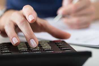 Close up of female using calculator