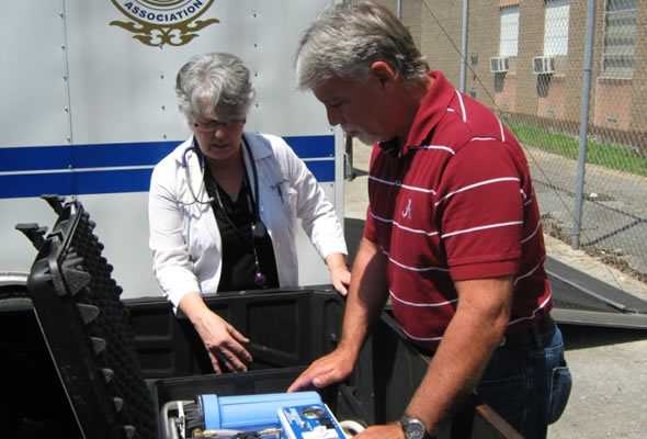 Emergency response staff reviewing steps to use a water purification unit.