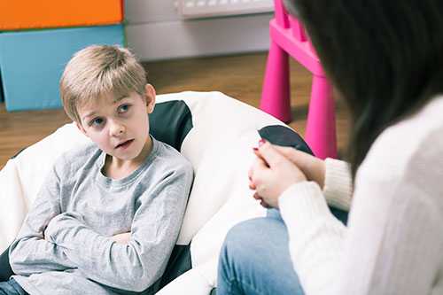 A young boy talking with his mother. 