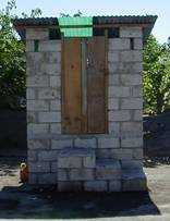 an ecological sanitation latrine, a structure over a container which stores organic waste for decomposition.