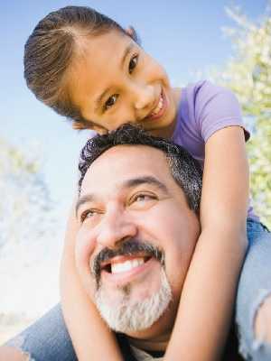 father and daughter smiling