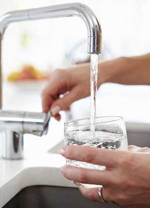 filling glass with water from faucet