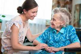 woman sitting and smiling with older woman