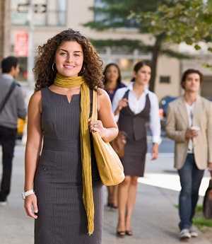 woman standing on city sidewalk