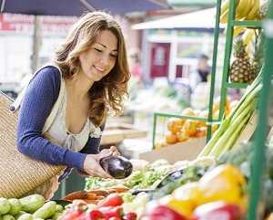 lady picking produce in grocery store