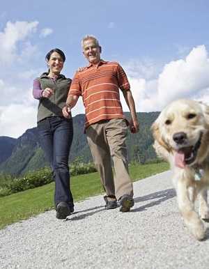 couple walking with dog outside