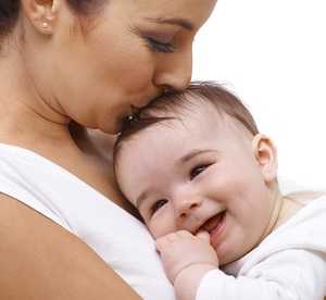 mother kissing baby's head