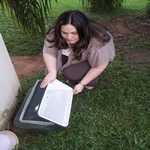 woman dumping water out of a cooler