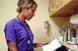 Image of a nurse reading a medical form