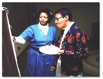 Two CHWs looking at a whiteboard.