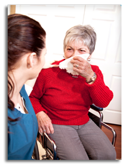 A CHW helping a woman in a wheelchair that has a cold.