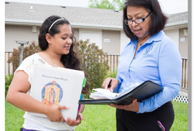 A CHW talking to a girl of school age.