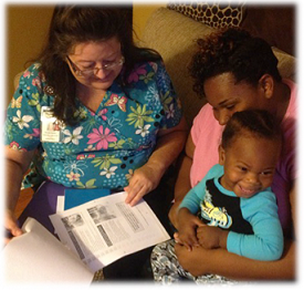 A CHW talking with a mother and her child.