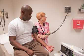 Man getting his blood pressure taken at the doctor's office.