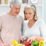 Couple cutting vegetables