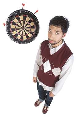 	man standing next to dart board