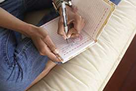 	woman writing in a journal